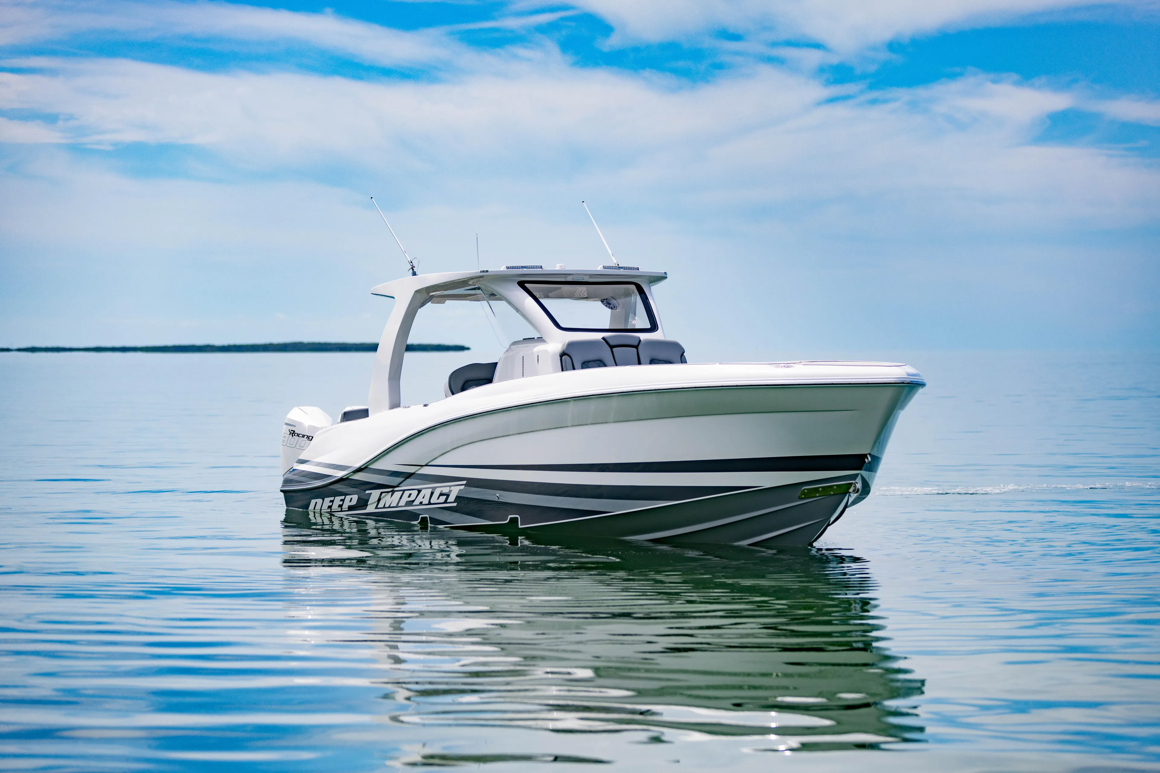  Yacht Photos Pics 2024 Deep Impact 369 boat on calm water under a blue sky.
