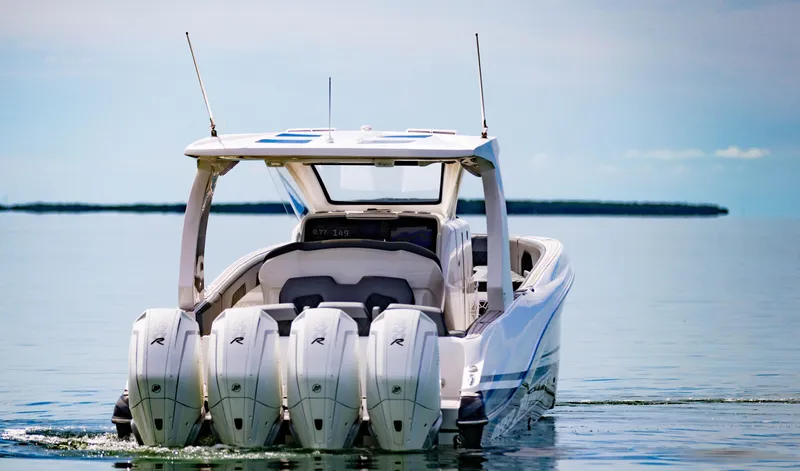  Yacht Photos Pics 2024 Deep Impact 369 Deep Impact boat with quad outboard engines on calm water.