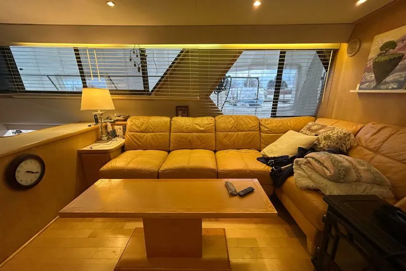 Contentment Yacht Photos Pics Cozy interior of 1995 Carver 440 Aft Cabin Motor Yacht with leather seating and wooden table.