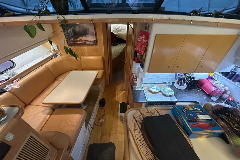 Contentment Yacht Photos Pics Interior of 1995 Carver 440 Aft Cabin Motor Yacht with cozy seating and kitchen area.