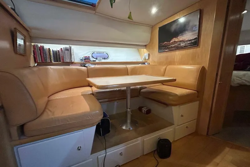 Contentment Yacht Photos Pics Interior of 1995 Carver 440 Aft Cabin Motor Yacht with cozy seating and table.