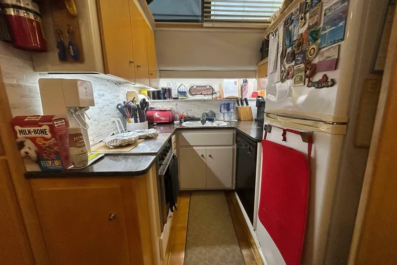 Contentment Yacht Photos Pics Compact kitchen in a 1995 Carver 440 Aft Cabin Motor Yacht, featuring modern appliances.