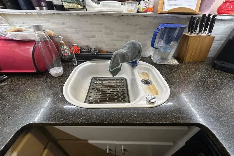 Contentment Yacht Photos Pics Kitchen sink area on a 1995 Carver 440 Aft Cabin Motor Yacht.