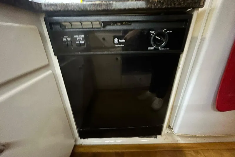 Contentment Yacht Photos Pics Built-in dishwasher on 1995 Carver 440 Aft Cabin Motor Yacht kitchen.