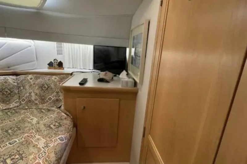 Contentment Yacht Photos Pics Interior of 1995 Carver 440 Aft Cabin Motor Yacht with cozy seating and wooden cabinetry.