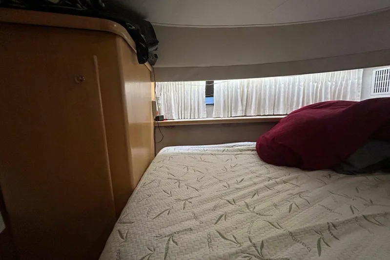 Contentment Yacht Photos Pics Cozy cabin interior of 1995 Carver 440 Aft Cabin Motor Yacht with bed and window.