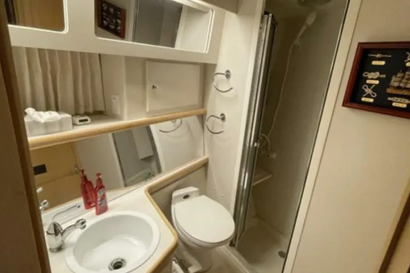 Contentment Yacht Photos Pics Bathroom interior of 1995 Carver 440 Aft Cabin Motor Yacht, featuring sink and shower.