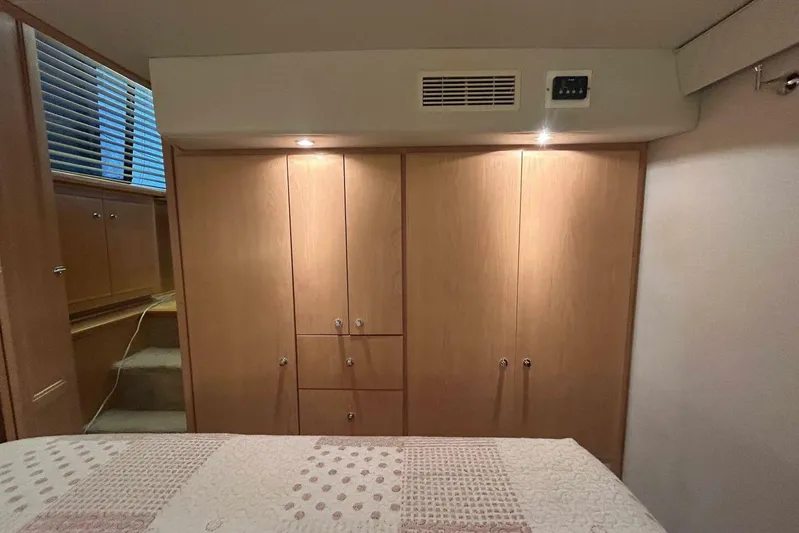 Contentment Yacht Photos Pics Interior of 1995 Carver 440 Aft Cabin Motor Yacht with wooden cabinetry and bed.