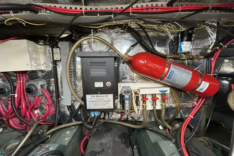 Contentment Yacht Photos Pics Engine room of 1995 Carver 440 Aft Cabin Motor Yacht with battery charger and fire extinguisher.