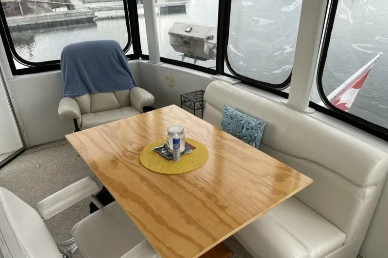 Contentment Yacht Photos Pics Interior of 1995 Carver 440 Aft Cabin Motor Yacht with dining area and lake view.