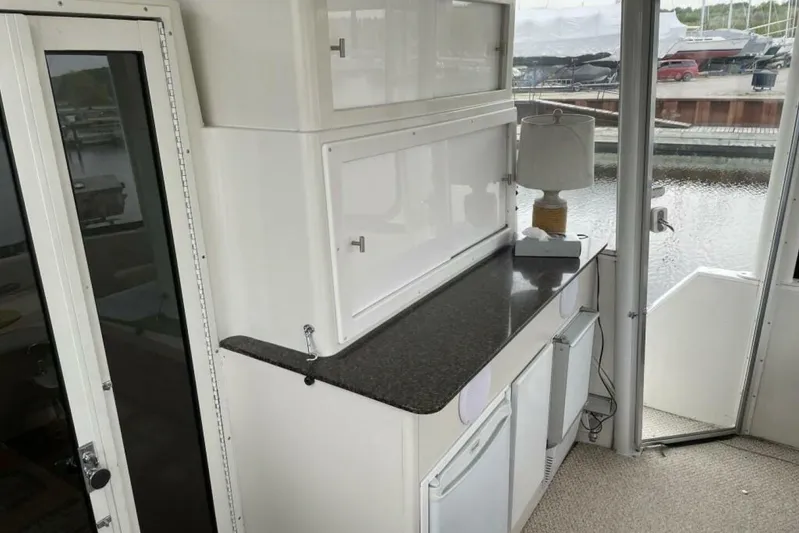 Contentment Yacht Photos Pics 1995 Carver 440 Aft Cabin Motor Yacht interior with countertop and lamp by window.