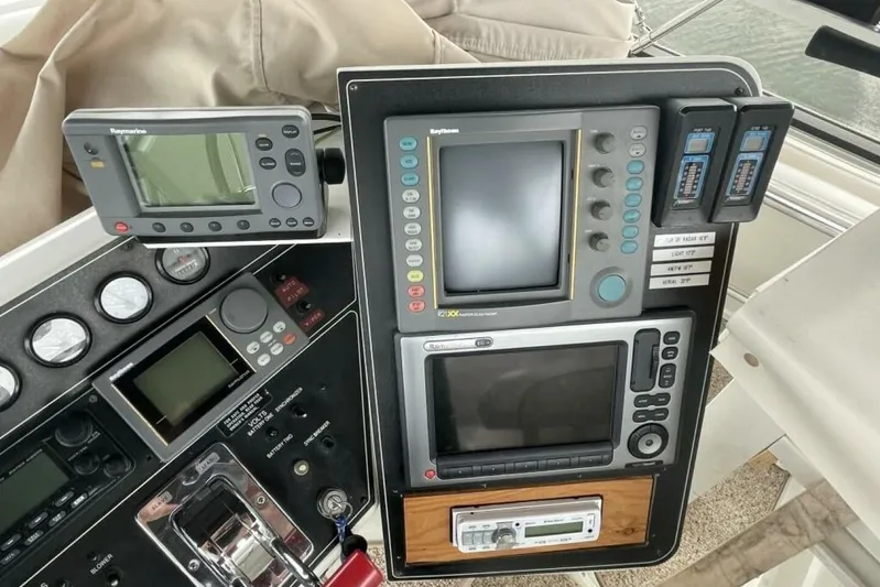 Contentment Yacht Photos Pics Control panel of a 1995 Carver 440 Aft Cabin Motor Yacht with navigation equipment.