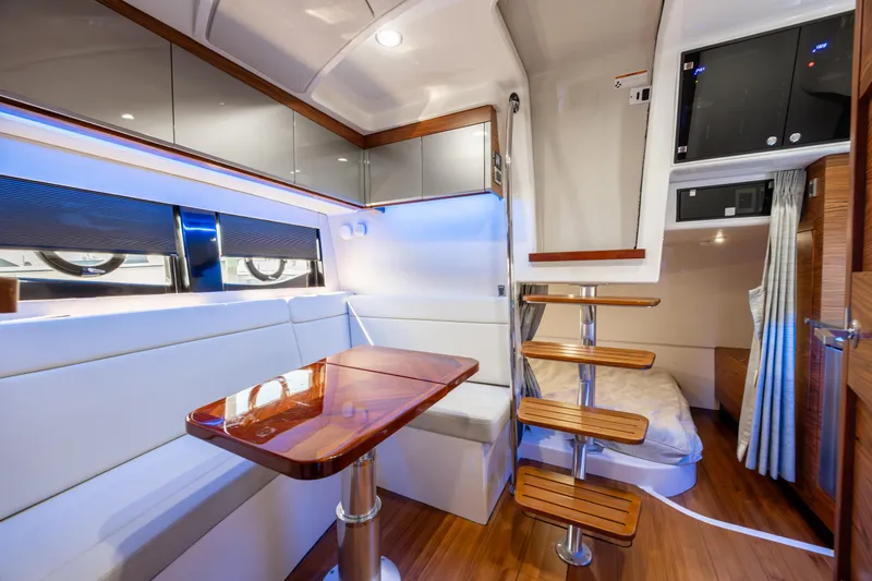 New Trade-in- All Offers & Trades Welcome Yacht Photos Pics Interior of 2021 Boston Whaler 405 Conquest yacht, featuring modern seating and wooden accents.