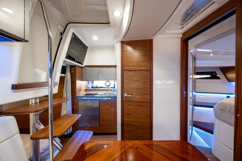 New Trade-in- All Offers & Trades Welcome Yacht Photos Pics Luxurious interior of 2021 Boston Whaler 405 Conquest yacht with modern kitchen and seating area.