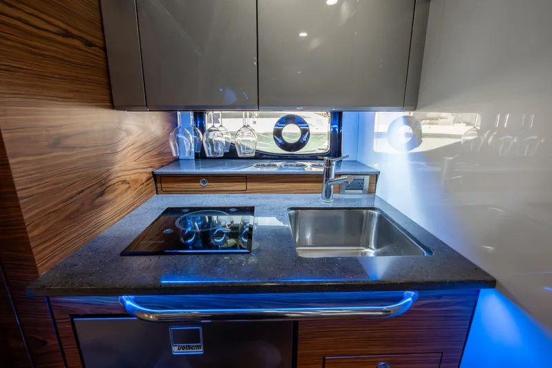 New Trade-in- All Offers & Trades Welcome Yacht Photos Pics Modern kitchen area in 2021 Boston Whaler 405 Conquest boat, featuring stove and sink.