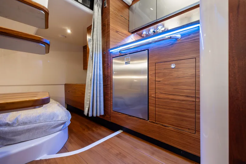 New Trade-in- All Offers & Trades Welcome Yacht Photos Pics Interior of 2021 Boston Whaler 405 Conquest, featuring modern wood finishes and compact kitchen area.