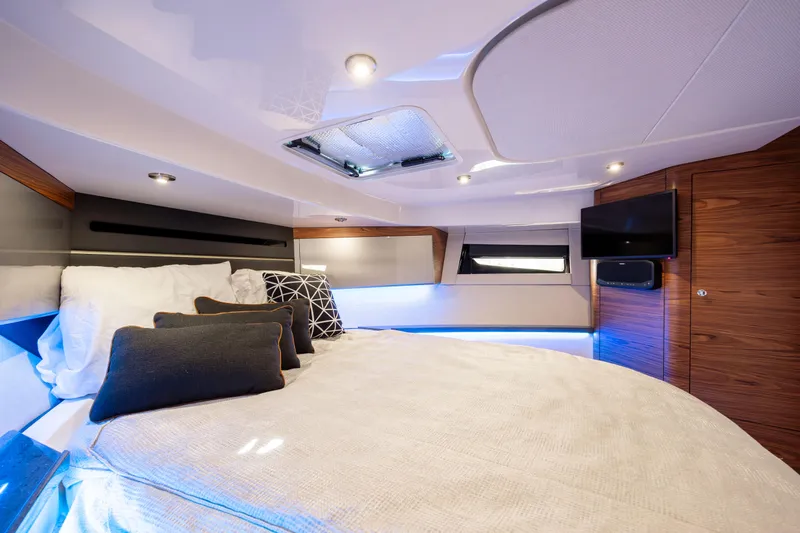 New Trade-in- All Offers & Trades Welcome Yacht Photos Pics Luxurious cabin interior of 2021 Boston Whaler 405 Conquest with modern lighting and cozy bedding.