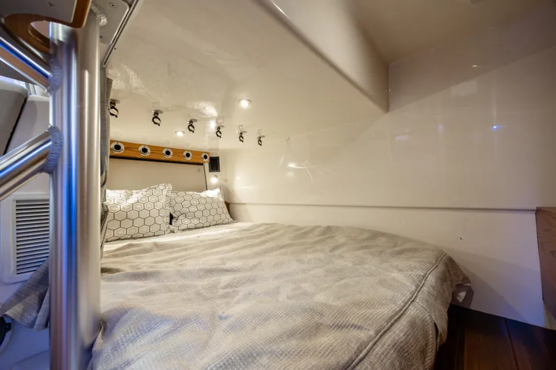 New Trade-in- All Offers & Trades Welcome Yacht Photos Pics Interior cabin of 2021 Boston Whaler 405 Conquest with cozy bedding and modern lighting.