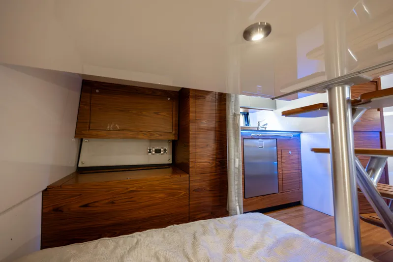 New Trade-in- All Offers & Trades Welcome Yacht Photos Pics Interior of 2021 Boston Whaler 405 Conquest, featuring modern wood cabinetry and compact kitchen area.