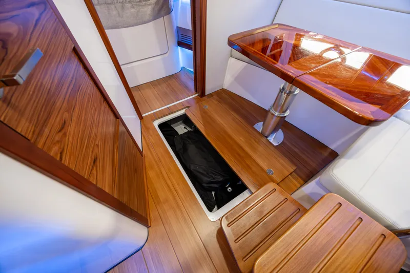 New Trade-in- All Offers & Trades Welcome Yacht Photos Pics 2021 Boston Whaler 405 Conquest interior with wood flooring and storage compartment.