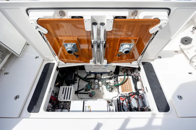 New Trade-in- All Offers & Trades Welcome Yacht Photos Pics Engine compartment of 2021 Boston Whaler 405 Conquest, showcasing mechanical components and storage.