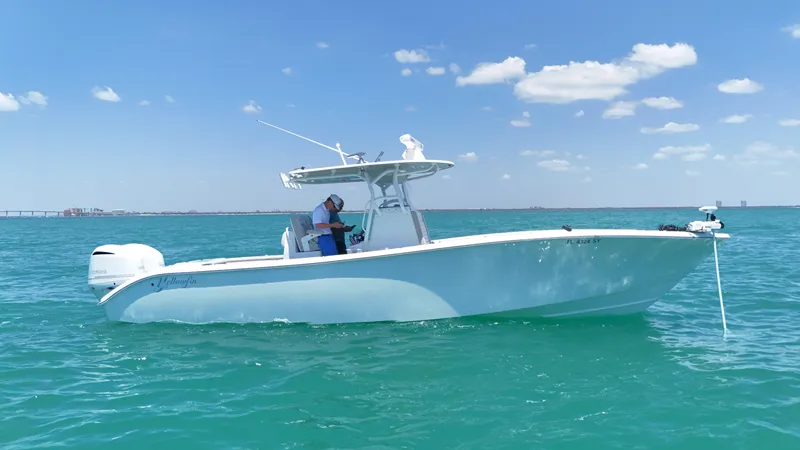  Yacht Photos Pics 2016 Yellowfin 32 Offshore boat on turquoise water under blue sky.