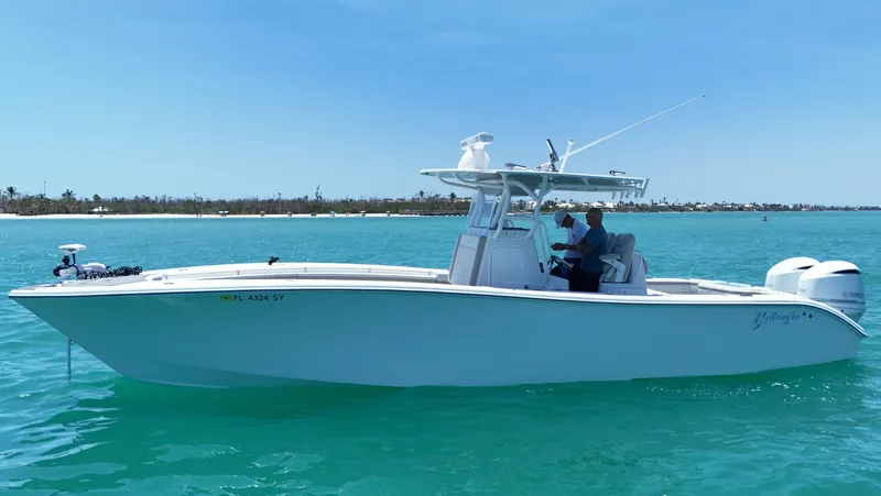  Yacht Photos Pics 2016 Yellowfin 32 Offshore boat on clear blue water, side view.