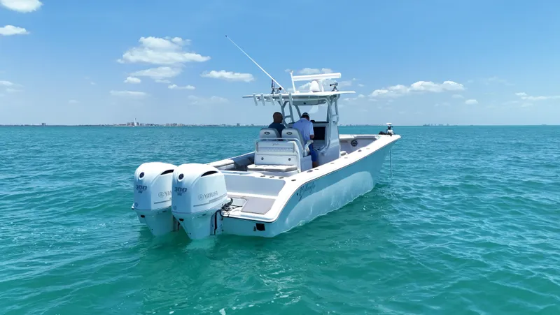  Yacht Photos Pics 2016 Yellowfin 32 Offshore boat cruising on clear blue ocean waters.