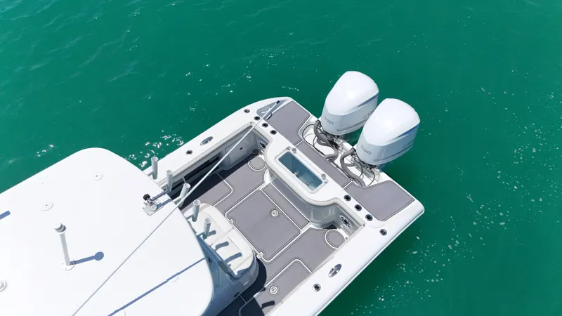  Yacht Photos Pics 2016 Yellowfin 32 Offshore boat with dual outboard motors on turquoise water.