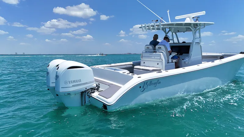  Yacht Photos Pics 2016 Yellowfin 32 Offshore boat cruising on clear blue water under a sunny sky.