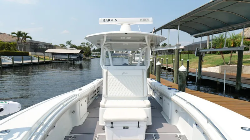  Yacht Photos Pics 2016 Yellowfin 32 Offshore boat docked, featuring Garmin equipment, in a sunny marina setting.