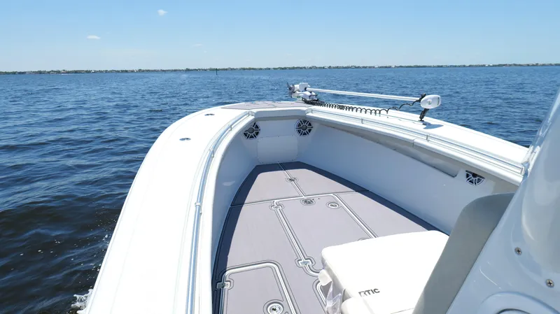  Yacht Photos Pics 2016 Yellowfin 32 Offshore boat on calm water, clear sky, spacious deck.