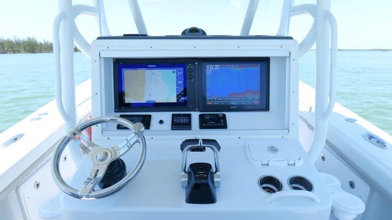  Yacht Photos Pics 2016 Yellowfin 32 Offshore boat dashboard with navigation screens and steering wheel.