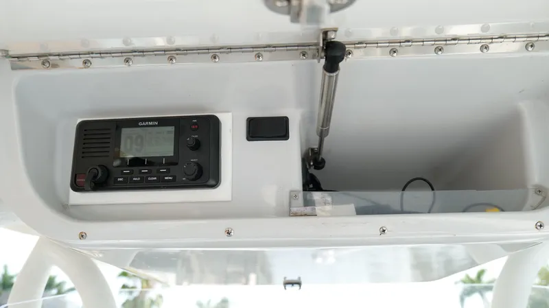  Yacht Photos Pics 2016 Yellowfin 32 Offshore boat console with Garmin radio and storage compartment.