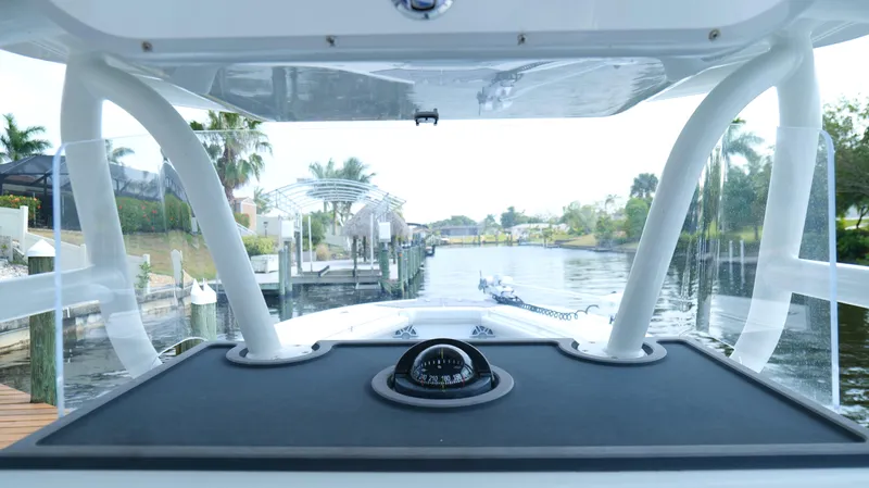  Yacht Photos Pics 2016 Yellowfin 32 Offshore boat navigating a scenic waterway with clear skies.