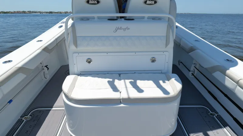  Yacht Photos Pics 2016 Yellowfin 32 Offshore boat interior with seating, on calm water.