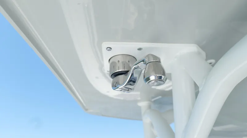  Yacht Photos Pics 2016 Yellowfin 32 Offshore boat detail, featuring a chrome fixture against a clear blue sky.