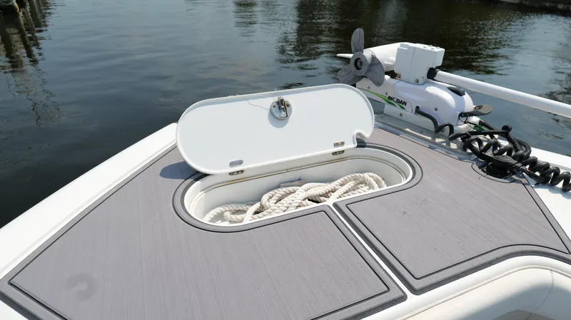  Yacht Photos Pics 2016 Yellowfin 32 Offshore boat with open storage compartment and coiled rope on deck.