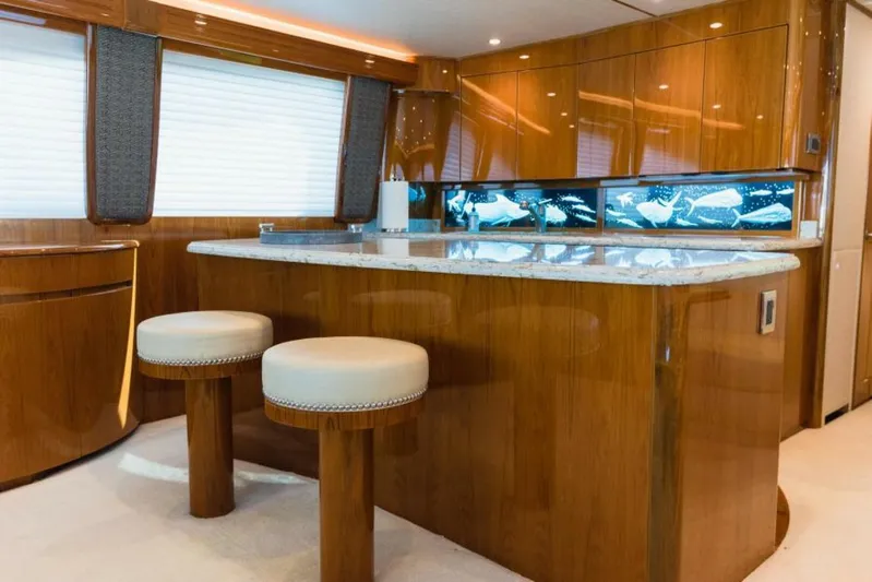 C Student Yacht Photos Pics Luxurious interior of 2017 Viking 66 Convertible yacht with elegant wood finishes and seating.