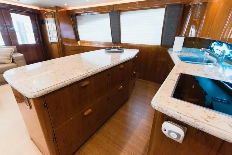 C Student Yacht Photos Pics Luxurious kitchen interior of 2017 Viking 66 Convertible yacht with marble countertops.