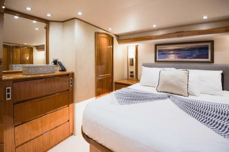 C Student Yacht Photos Pics Luxurious bedroom interior of 2017 Viking 66 Convertible yacht with elegant wood finishes.
