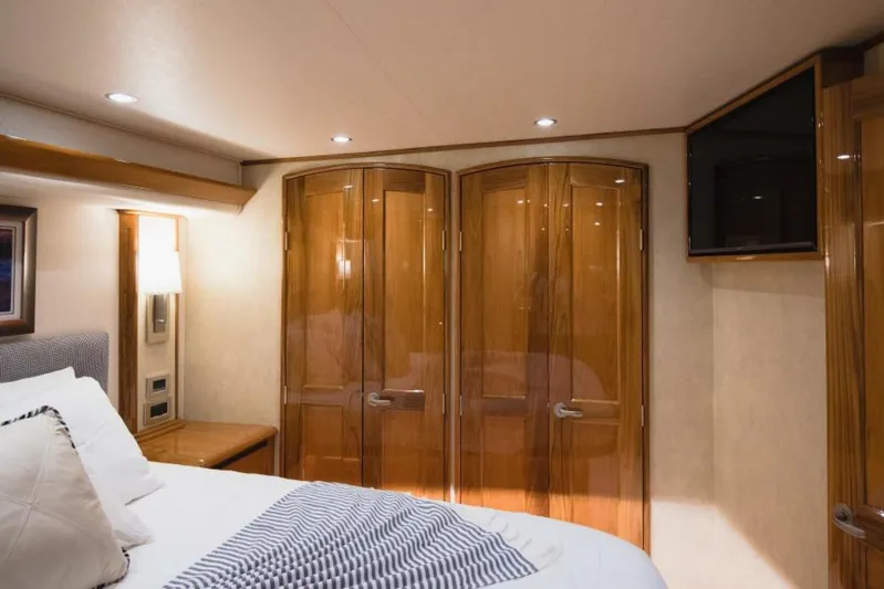 C Student Yacht Photos Pics Luxurious bedroom interior of 2017 Viking 66 Convertible yacht with wooden cabinetry.