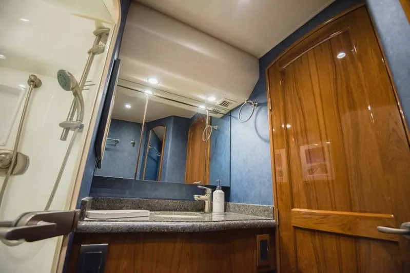 C Student Yacht Photos Pics Luxurious bathroom in 2017 Viking 66 Convertible yacht with wooden accents and modern fixtures.