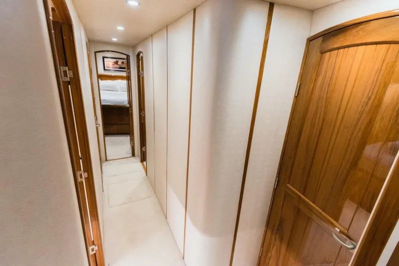 C Student Yacht Photos Pics Interior hallway of 2017 Viking 66 Convertible yacht with wooden doors and soft lighting.
