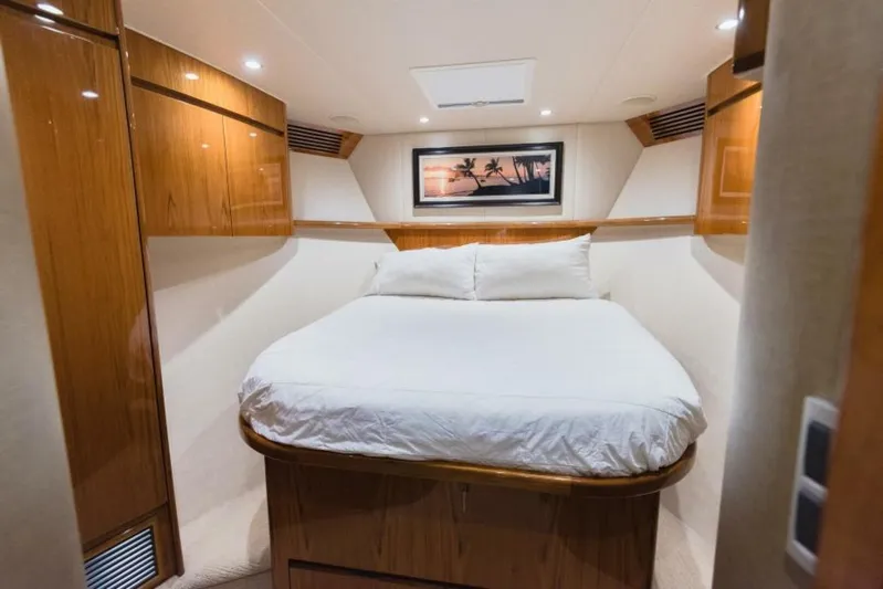 C Student Yacht Photos Pics Luxurious bedroom interior of 2017 Viking 66 Convertible yacht with wood paneling.