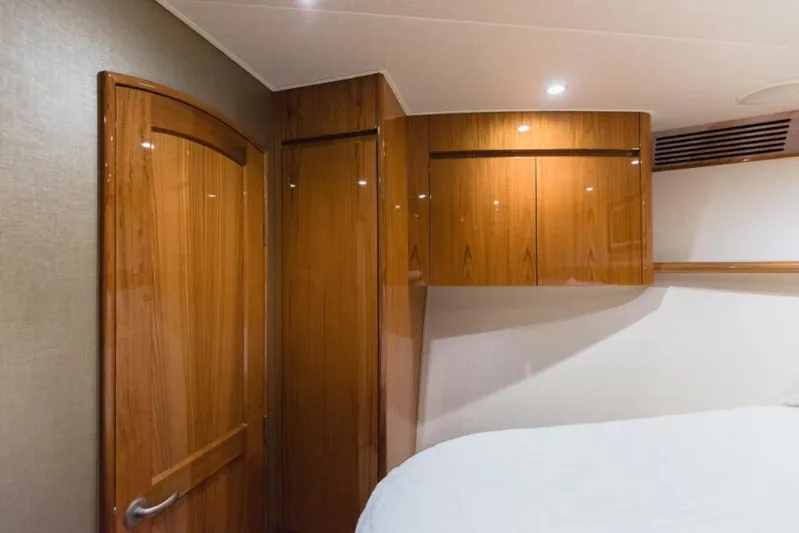 C Student Yacht Photos Pics Luxurious wood interior of 2017 Viking 66 Convertible yacht bedroom.