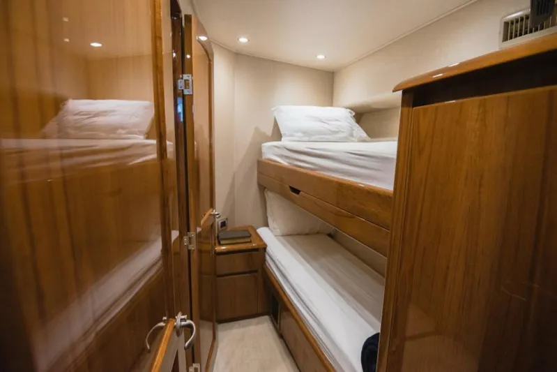 C Student Yacht Photos Pics 2017 Viking 66 Convertible yacht cabin with wooden bunk beds and cozy lighting.