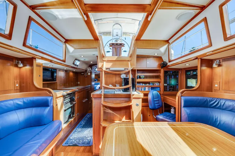 Liberte' Yacht Photos Pics Luxurious 2011 Hylas 46 yacht interior with wood finish and blue seating.