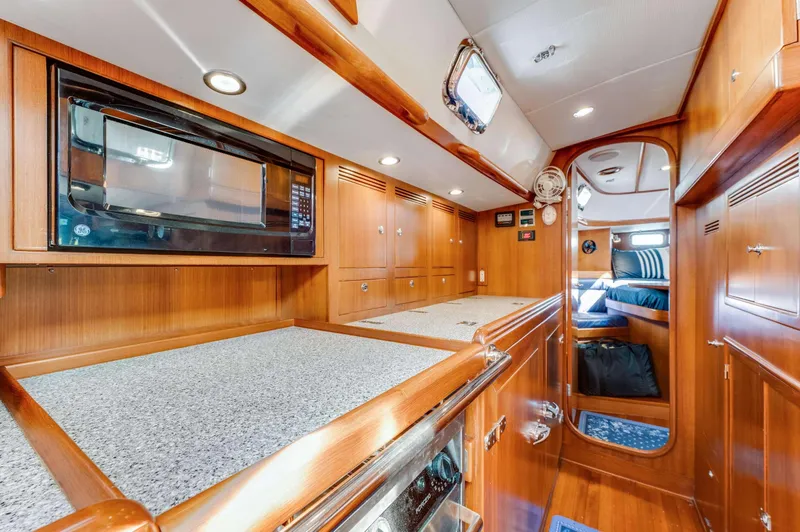 Liberte' Yacht Photos Pics Luxurious interior of 2011 Hylas 46 yacht with modern kitchen and cozy cabin.