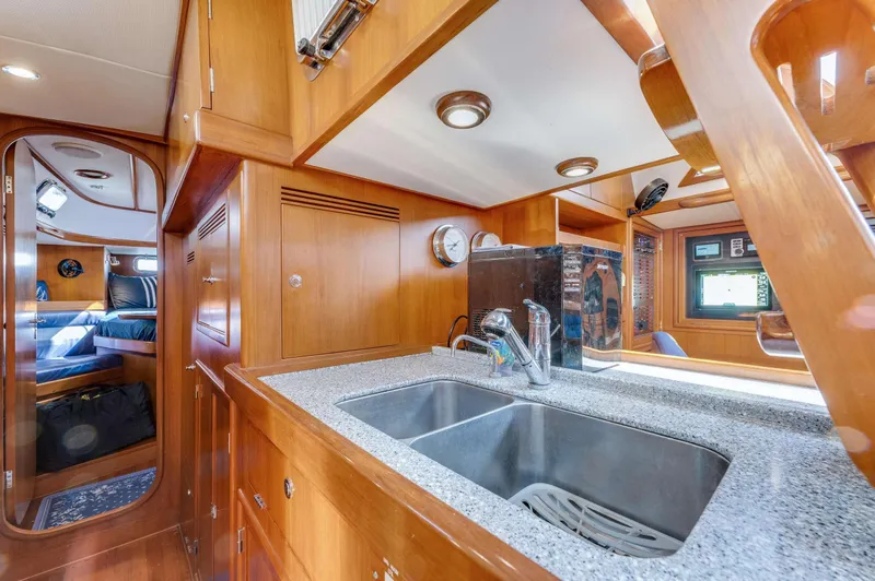 Liberte' Yacht Photos Pics Interior of 2011 Hylas 46 yacht featuring a modern kitchen with wood cabinetry.